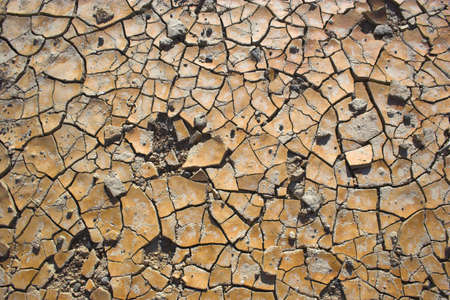 Fragment of  orange clay and salt mineral deposits in geological formations in Ubehebe Volcano,...