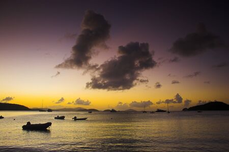Boats off the shore at the tropical island during sunset. Photos in this series have been filtered using colored filtersの写真素材