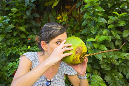 Girl with fresh coconut at the tropical island in Caribbean の写真素材