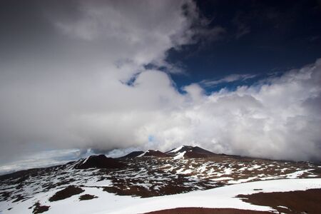Volcanic landscape and snow on the summit of Mauna Kea in Hawaiiの写真素材