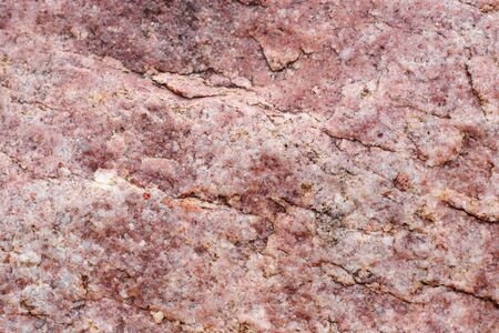 Textured uneven pink stone surface