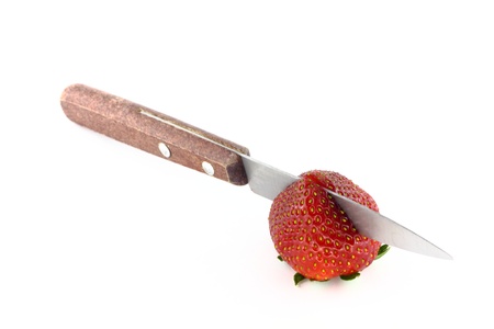 Strawberry with knife on the white backgroundの写真素材