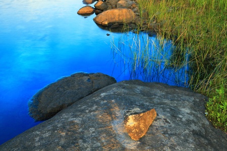 Rocky lake shore fragment at twilightの写真素材