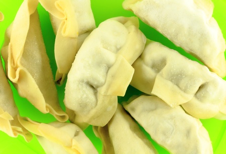 Frozen dumplings on green plate ready to be boiledの写真素材