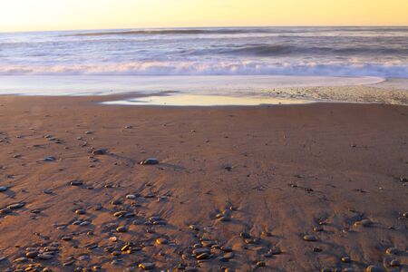 Strong tidal waves during sunset in Pacific Ocean