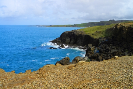 Rocky outcrop and blue ocean in Catlins, New Zealand