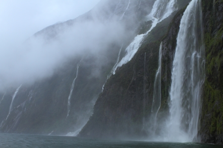 Beautiful waterfalls during the rainstorm in Fiordland National Park, New Zealandの写真素材