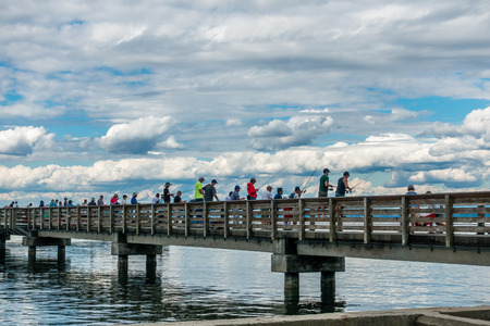 Fishermen try their luck at Dash Point in Wahsington State.  It's July and the Salmon are running.のeditorial素材