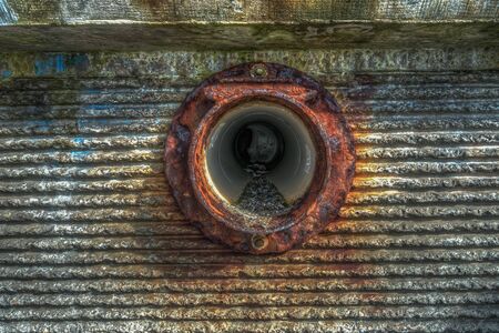 A view of a sewer outlet in a wall at Redondo Beach, Washington. HDR image.の写真素材