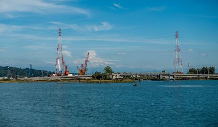 Mount Rainier rises up behine power lines at the Port of Tacoma.の写真素材