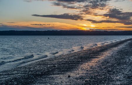 A view of a sunset from Three Tree Point in Burien, Washington.