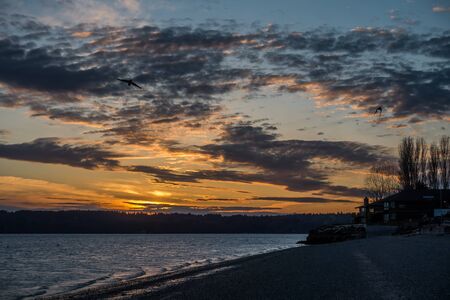 A view of a sunset from Three Tree Point in Burien, Washington.