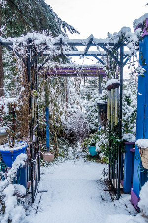Fresh snow covers a porch with a trellis.の写真素材
