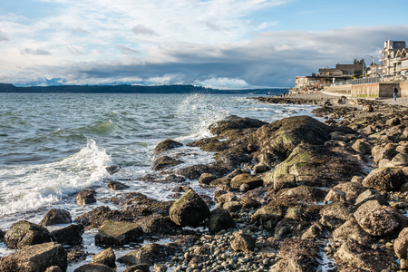 A veiw of the rocky shoreline in West Seattle, Washington.の写真素材