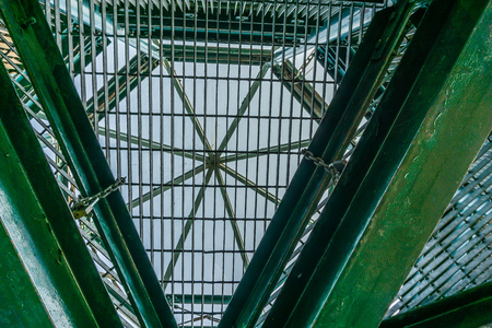 A view of a metal structure from below with beams crossing in different directions.の写真素材