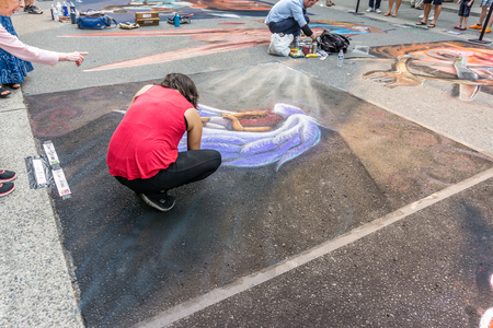 REDMOND, WA. /  USA - AUGUST 19TH 2018: An artist works at the Chalkfest event in Redmond, Washington.The locations is Redmond Town Center.のeditorial素材