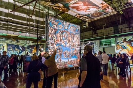 Tacoma, WA, USA - October 11, 2018        Art lovers appreciate the hangings at the Michaelangelo Sistine Chapel art exhiibt. Location is the Tacoma Armory.のeditorial素材