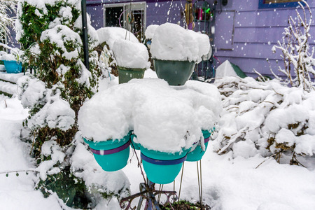 Planters topped with snow resemble showcones.の写真素材