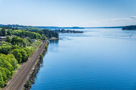 Railroad tracks along the shore of the Tacoma Narrows waterway.の写真素材