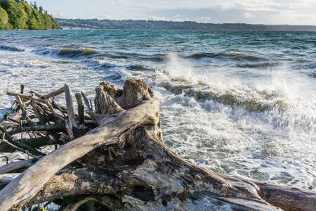 Wave from the Puget Sound hit rocks on the shoreline in Des Moines, Washington.の写真素材