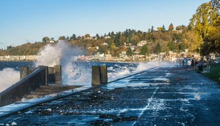 Waves crash onto the shore at Alki Beach in West Seattle, Washington.の写真素材