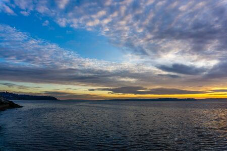 An overcast cloudy sunset over the Puget Sound in West Seattle, Washington.