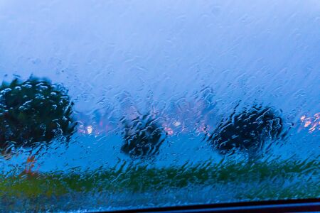 A view from behind a rain-covered windsield of the Seattle skylineの写真素材