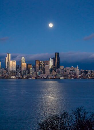A bright full moon shines over the Seattle skyline.の写真素材