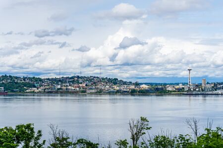 Fluffy clouds hover over Seattle, Washington.の写真素材