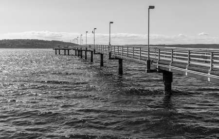 The bright sun in reflected on the water at the Des Moines pier in Washington State.