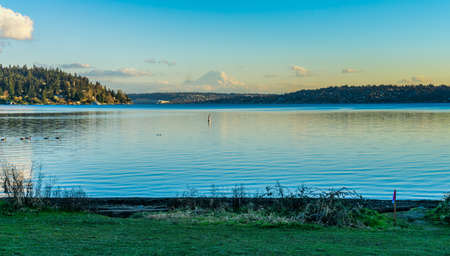 A view of Mount Rainier across Lake Washington from Seward Park in Seattle.の写真素材