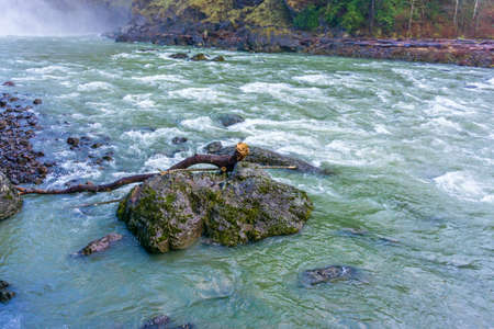 Water rushes along in the Snoqualmie River in Washington State.