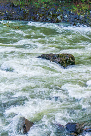 Water rushes along in the Snoqualmie River in Washington State.の写真素材