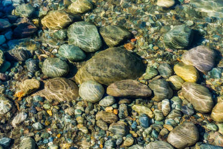A background shot of rocks under clear water in Washington State.の写真素材