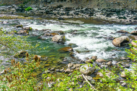 Rapids over rocks in the Snoqualmie River in Washington State.の写真素材