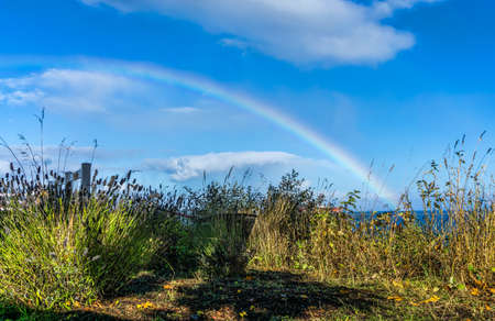 A rainbow in Port Angeles, Washington. Blue sky.の写真素材