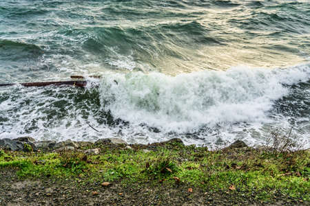 The sea assails the shoreline in West Seattle, Washington.の写真素材