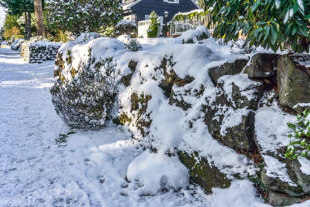 Snow lies on a wall in Burien, Washington.