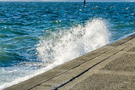 Wave crash onto the sholeline in West Seattle, Washington.の写真素材