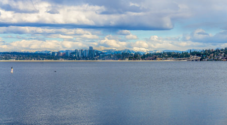 The cascdes mountain range has snow with Bellevue, Washington in front.の写真素材