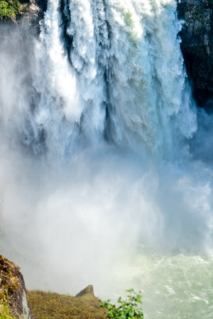 Water crashes off the bottom of Snoqualmie Falls in Washington State.の写真素材