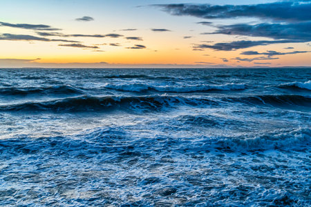 In the vening waves roll onto the shore in Oak Harbor, Washington.