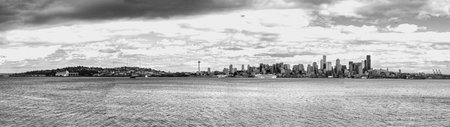 A wide panorama shot of the skyline in Seattle, Washington. Black and white photo.