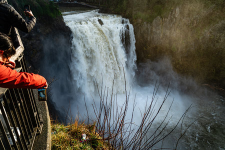 Tons of water rush over the edge at Snoqualmie Falls in Washington State.