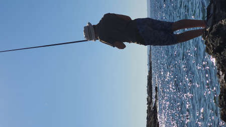 A young man fishing at Dekelia area at Ormidia village, in Cyprus Republic.の写真素材