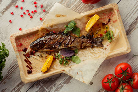 Photographing food flat lay Caucasian cuisine. Delicious Georgian dish on the table. Grilled fish.の写真素材