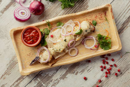 Photographing food flat lay Caucasian cuisine. Delicious Georgian dish on the table. Grilled fishの写真素材