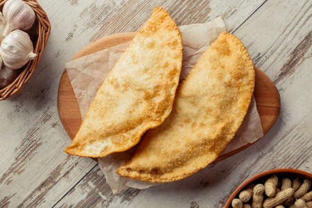 Georgian dish on the table photo for the menu of Eastern Caucasian cuisine. Cheburek flat layの写真素材