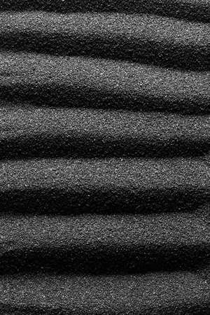 Black sand dunes background. Bump trace. Creative sand relief