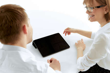 A girl Bank employee and a guy client discuss the terms of deposits and loans with an excellent...